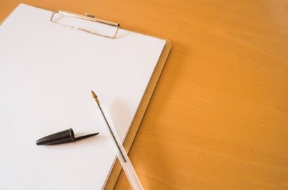 A pen and paper with a half-written cover letter