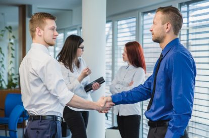 People shaking hands at a networking event